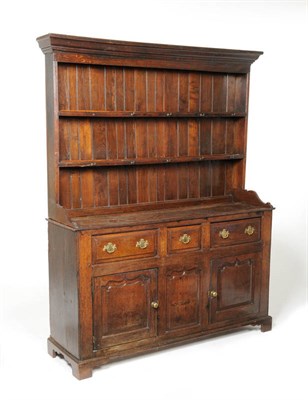 Lot 1488 - A George II Oak Enclosed Tall Dresser and Rack, mid 18th century, the ovolo pediment above a...