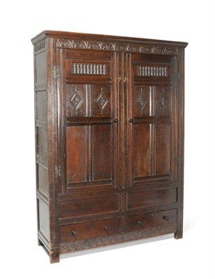 Lot 1489 - A Joined Oak Press Cupboard, the lunette carved frieze above two conforming panel doors with fluted