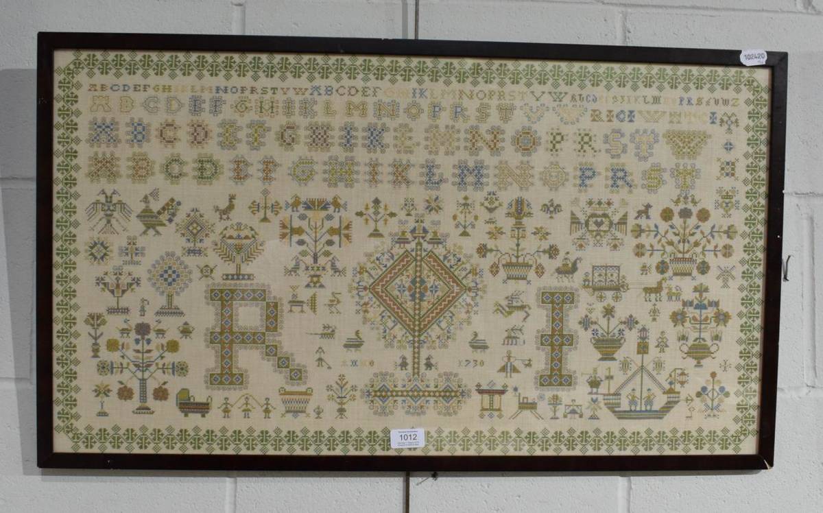 Lot 1012 - A modern cross stitch alphabet sampler bearing a date 1730