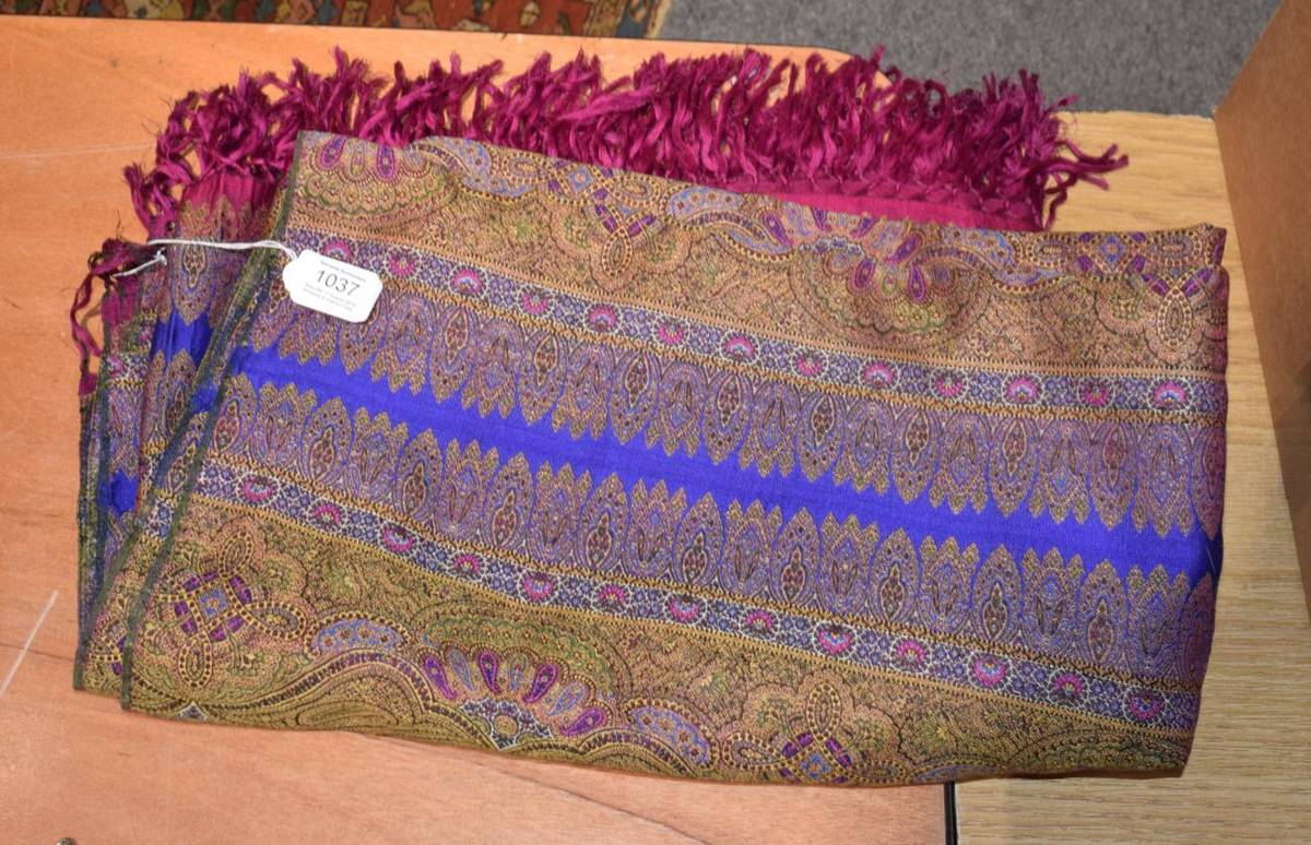 Lot 1037 - A Late 19th century paisley shawl woven with decorative bands with purple, pink border and...