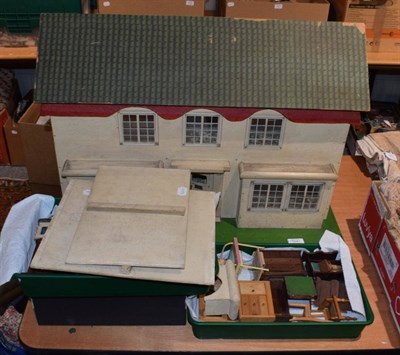 Lot 1041 - Circa 1930s Triang style dolls house; assorted dolls furniture; accessories; bisque baby dolls; and