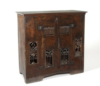 Lot 1492 - An Oak Gothic Style Aumbry, the two cupboard doors with linen fold panels and pierced Gothic...