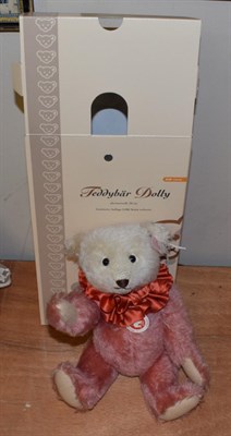 Lot 1076 - Modern Steiff Teddy Bear Dolly, in dusty pink and white, with red ruffle to the neck, boxed...