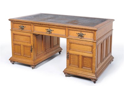 Lot 1496 - An Oak Double Pedestal Desk, circa 1900, the worn brown and gilt leather skiver above three...