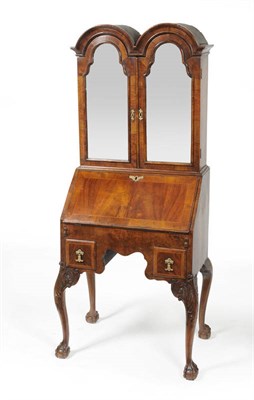 Lot 1503 - An Early Georgian Style Bureau Bookcase, the double arched pediment above two mirror doors...