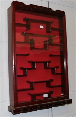 Lot 1251 - A Chinese style rosewood glazed hanging display cabinet