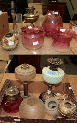 Lot 1256 - Three oil lamp bases and a collection of etched and other cranberry and clear glass shades etc