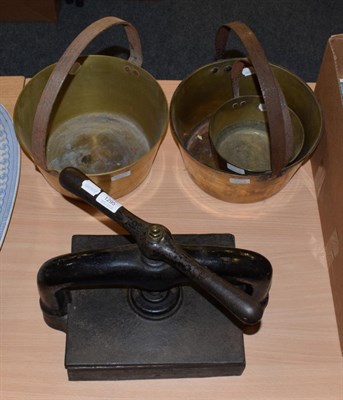 Lot 1295 - A Victorian book press by Parkins & Co, London; and a graduated set of three brass jam pans