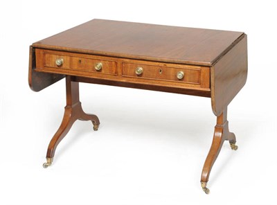 Lot 1512 - A George III Mahogany Sofa Table, circa 1800, the rectangular top with two rounded drop leaves...