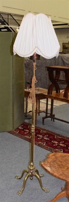 Lot 1321 - Late Victorian brass adjustable standard lamp, with four paw feet