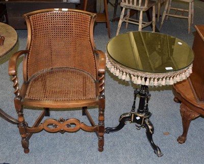 Lot 1325 - A cane seated armchair; and an ebonised tripod table