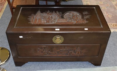Lot 1354 - An Oriental camphor wood carved blanket chest