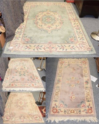 Lot 1357 - A carved Chinese carpet of Savonnerie design, the field with an oval medallion enclosed by...