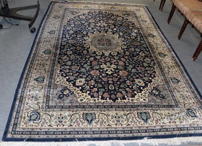 Lot 1359 - A machine made carpet of Oriental design, 284cm by 198cm