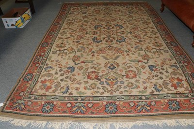 Lot 1360 - An Oriental carpet, the cream field of floral vines enclosed by terracotta borders, 364cm by 241cm