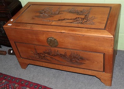 Lot 1385 - A Chinese camphor wood chest with carved top