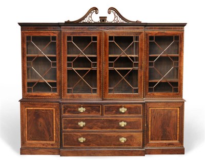 Lot 1523 - A George III Style Mahogany and Satinwood Banded Four Door Breakfront Bookcase, incorporating...