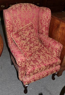 Lot 1432 - A modern wing back armchair