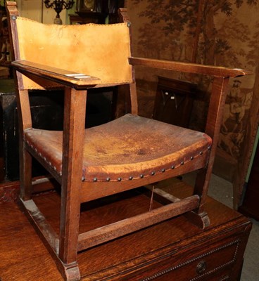 Lot 1476 - A Gomme fireside oak armchair, circa 1929, model 105, with tan hide seat and back, stamped...