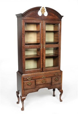 Lot 1530 - A George III Mahogany Bookcase on Stand, late 18th century, the swan neck bonnet pediment with gilt