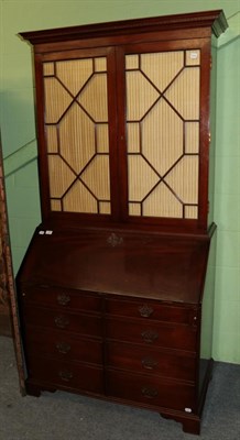 Lot 1490 - A George III style mahogany secretaire bookcase