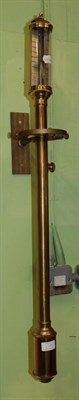 Lot 1512 - A reproduction brass ships barometer suspended on a wall gimbal bracket