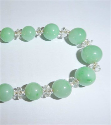 Lot 2009 - A Jade and Rock Crystal Necklace, spherical jade beads spaced by faceted and smooth rock...