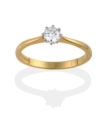 Lot 2011 - An 18 Carat Gold Diamond Solitaire Ring, the round brilliant cut diamond in white claws on a yellow