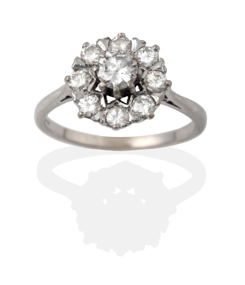 Lot 2022 - A Diamond Cluster Ring, the round brilliant cut diamonds in white claw settings to a tapered...