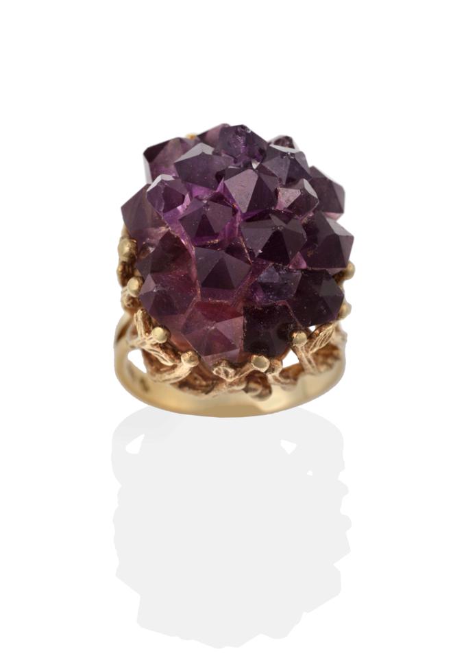 Lot 2027 - An Amethyst Crystal Ring, the amethyst of natural form, in a textured leaf motif and bead...