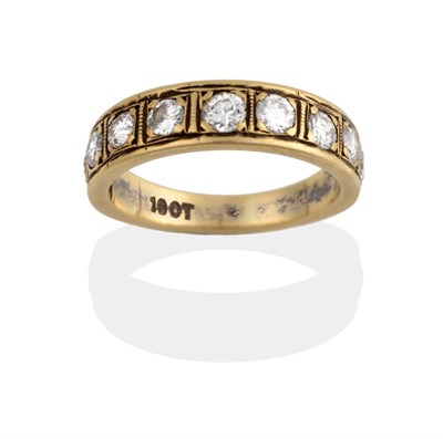 Lot 2034 - A Diamond Half Hoop Ring, nine graduated round brilliant cut diamonds in yellow claw settings...