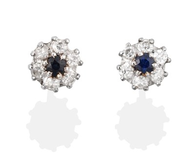 Lot 2044 - A Pair of 18 Carat White Gold Sapphire and Diamond Cluster Earrings, the round brilliant cut...