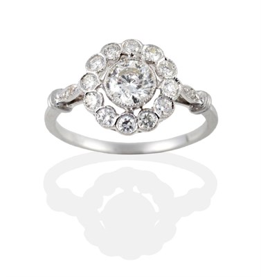 Lot 2045 - An 18 Carat White Gold Diamond Cluster Ring, the round brilliant cut diamonds in millegrain...