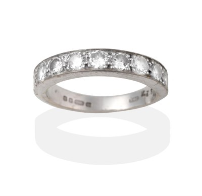 Lot 2048 - An 18 Carat White Gold Diamond Half Hoop Ring, nine round brilliant cut diamonds in white claw...