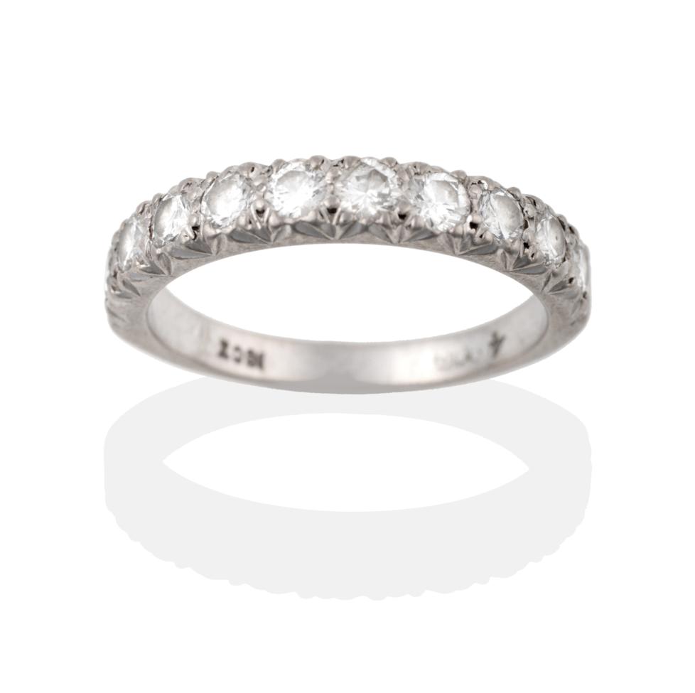 Lot 2051 - A Diamond Half Hoop Ring, ten round brilliant cut diamonds in white claw settings to a tapering...