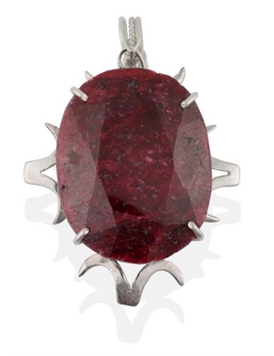 Lot 2068 - A Ruby Pendant, the oval cut ruby in a white claw setting to a scroll border, measures 5cm by 6.6cm