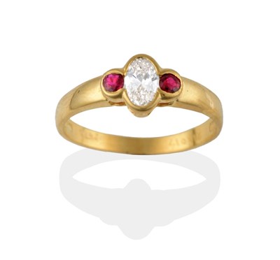 Lot 2072 - An 18 Carat Gold Diamond and Ruby Three Stone Ring, a central oval cut diamond flanked by a...