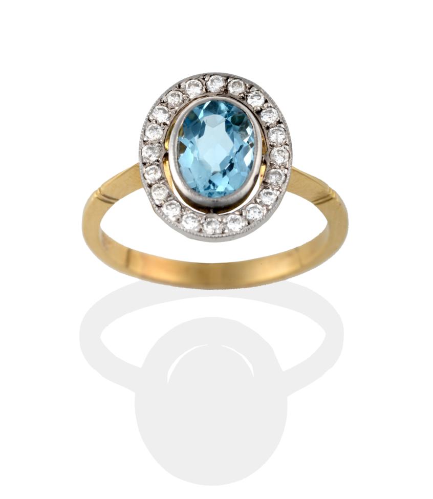 Lot 2084 - An Aquamarine and Diamond Cluster Ring, the oval cut aquamarine in a white rubbed over setting,...
