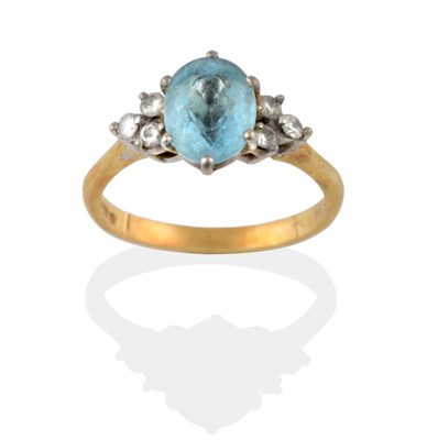 Lot 2086 - An 18 Carat Gold Aquamarine and Diamond Ring, the oval cut aquamarine flanked by a trio of diamonds