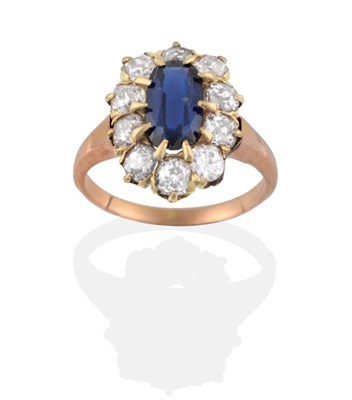 Lot 2090 - A Synthetic Sapphire and Diamond Cluster Ring, the oval cut synthetic sapphire within a border...