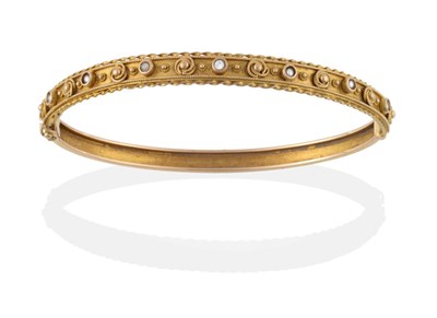 Lot 2098 - A 14 Carat Gold Bangle, of decorative form, one half with a diamond and several split pearls...