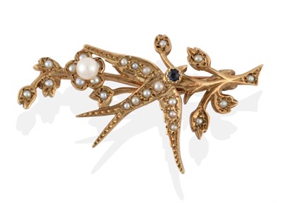 Lot 2099 - A 9 Carat Gold Seed Pearl and Sapphire Swallow Brooch, realistically modelled in flight with a...