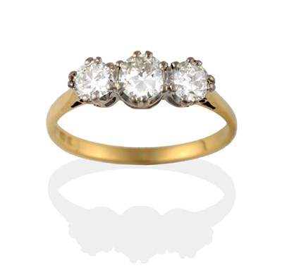 Lot 2100 - An 18 Carat Gold Diamond Three Stone Ring, the old brilliant cut diamonds in a white claw...