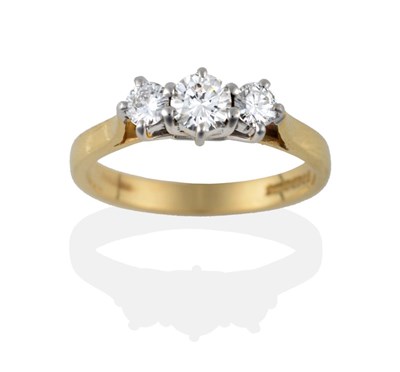 Lot 2103 - An 18 Carat Gold Diamond Three Stone Ring, the graduated round brilliant cut diamonds in white claw
