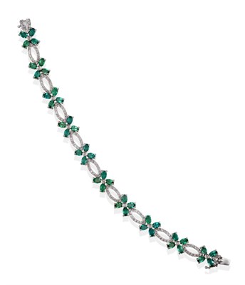 Lot 2116 - An Emerald and Diamond Bracelet, ten floral style clusters comprised of four oval cut emeralds...