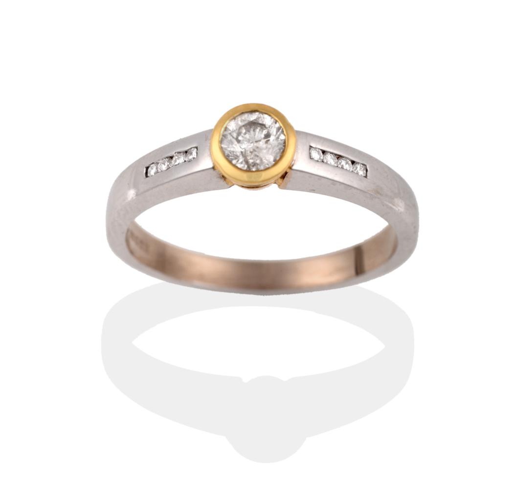 Lot 2118 - An 18 Carat Gold Diamond Ring, a round brilliant cut diamond in a yellow rubbed over setting,...