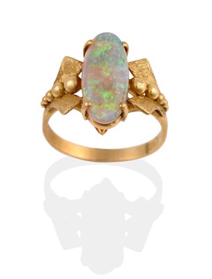 Lot 2142 - A Synthetic Opal Ring, an oval cabochon opal in a yellow four claw setting, to fancy polished...