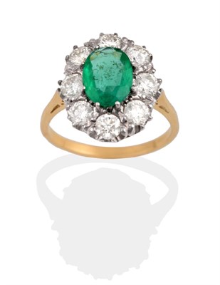 Lot 2145 - An Emerald and Diamond Cluster Ring, the oval cut emerald within a border of round brilliant...
