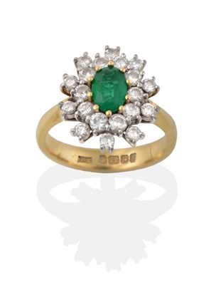 Lot 2156 - A 22 Carat Gold Emerald and Diamond Cluster Ring, an oval cut emerald in yellow claw settings...