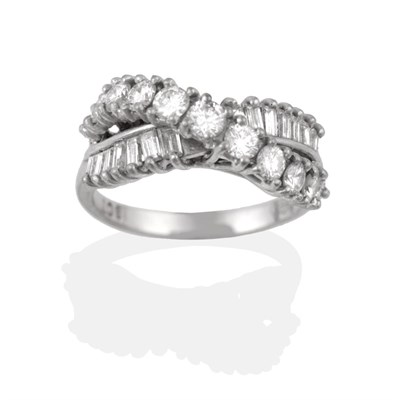 Lot 2164 - A Diamond Ring, two rows of diamonds in a crossover design, one row of baguette cut diamonds,...